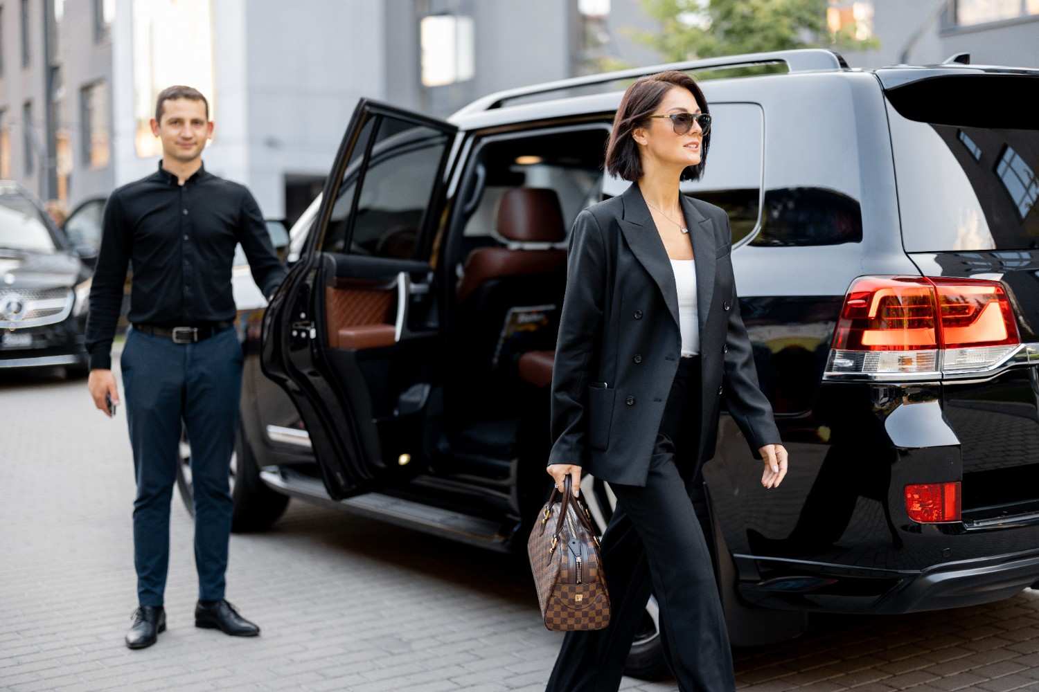 male-driver-helps-business-lady-