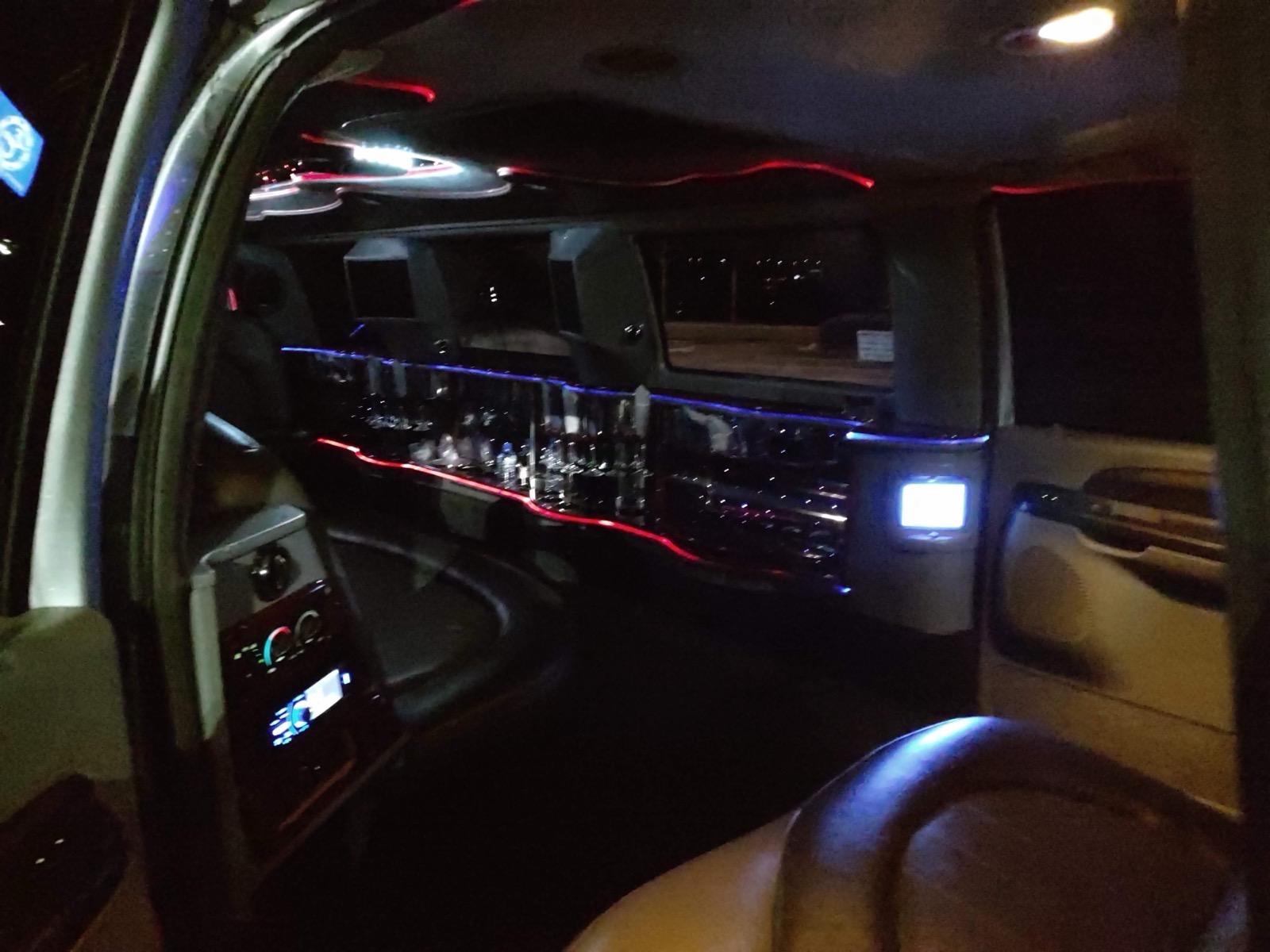 Airport SUV FL luxury limousine interior with premium leather seating and ambient lighting for comfortable chauffeur service in Florida.