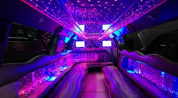 Luxury limo interior with purple LED lighting for Bachelor Party Limo Service and special event transportation.